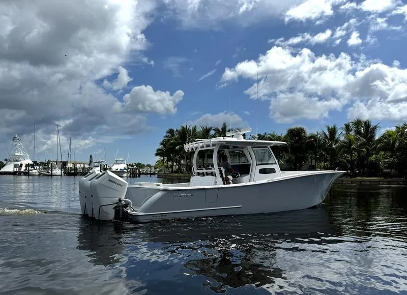 Slide: The Image of 2025 Phenom 37 boat on calm water under cloudy sky. - 1