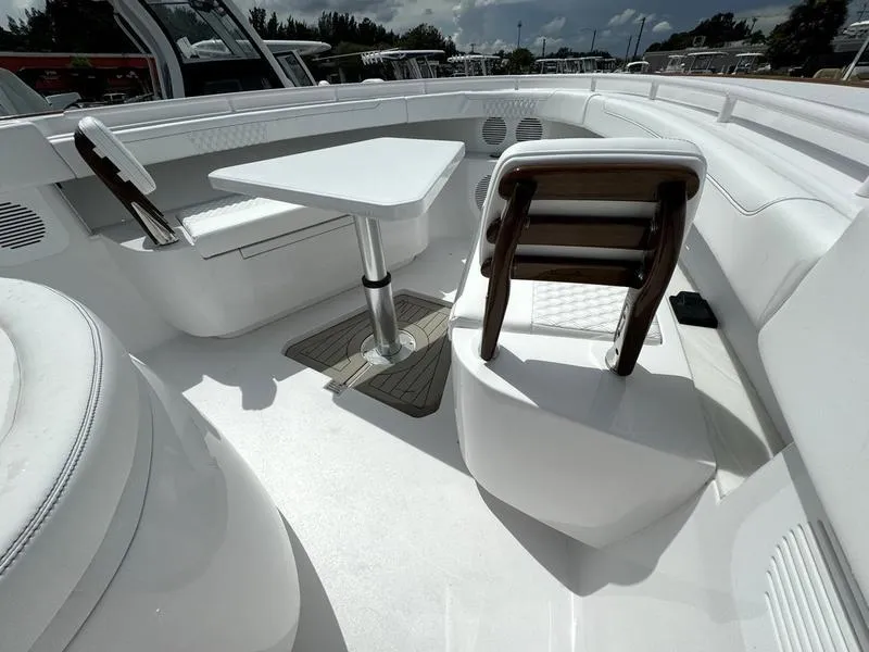 Slide: The Image of Luxurious seating area on 2025 Phenom 37 boat with table and chairs. - 11