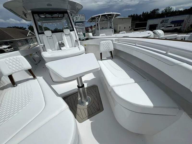 Slide: The Image of 2025 Phenom 37 boat interior with white seating and table. - 12