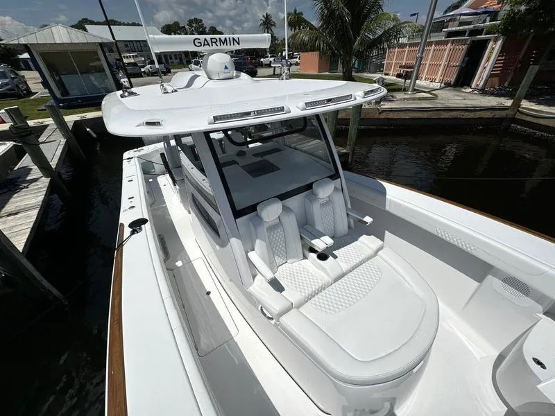 Slide: The Image of 2025 Phenom 37 boat with Garmin equipment, docked near palm trees. - 13