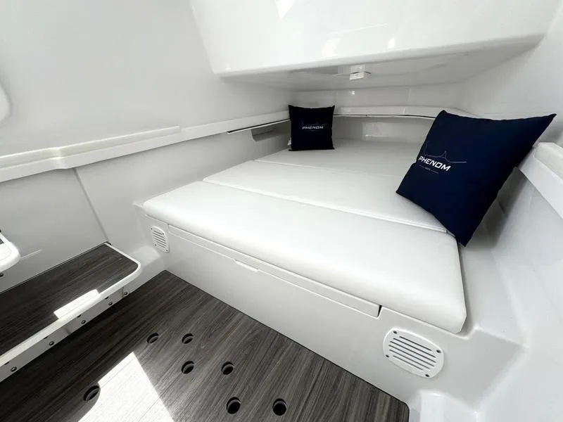 Slide: The Image of 2025 Phenom 37 boat interior with white seating and branded cushions. - 28