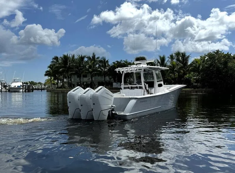 Slide: The Image of 2025 Phenom 37 boat with triple engines on a calm waterway. - 3