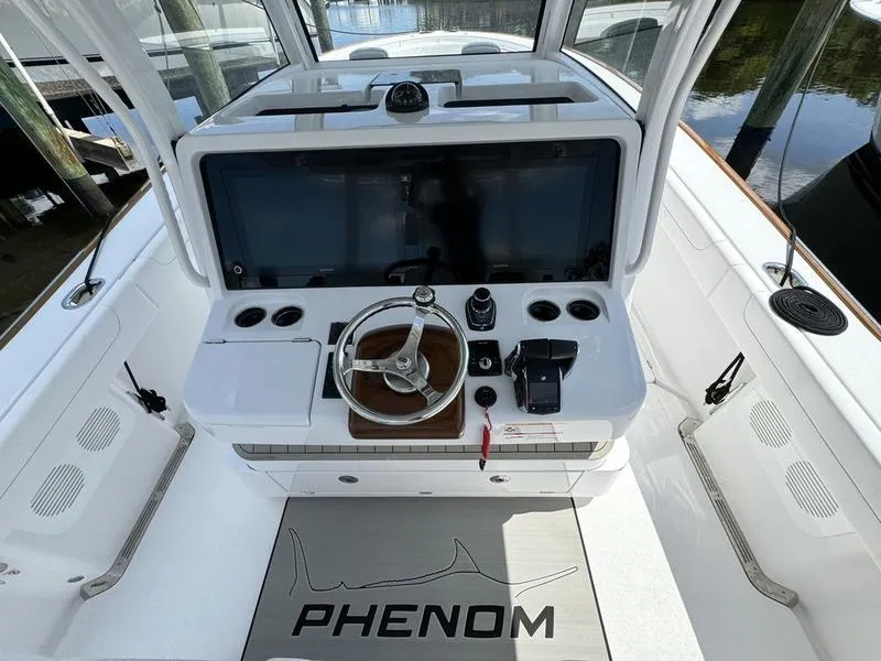 Slide: The Image of Phenom 37 boat dashboard, 2025 model, featuring modern steering and controls. - 31