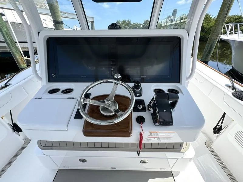 Slide: The Image of 2025 Phenom 37 boat helm with steering wheel and control panel. - 32