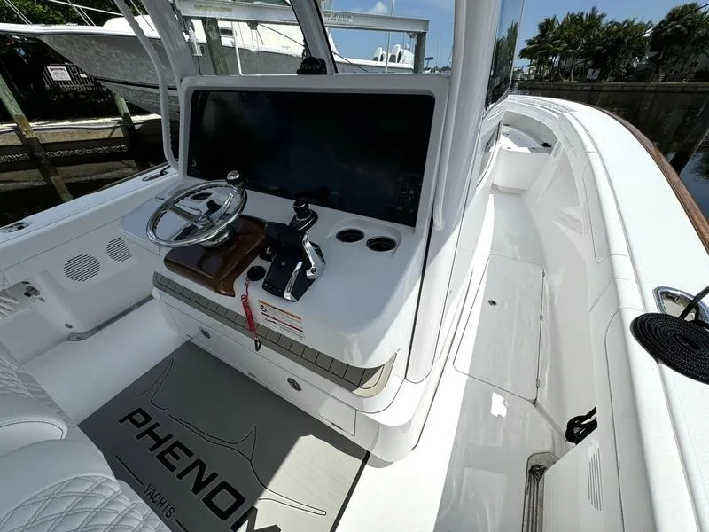 Slide: The Image of 2025 Phenom 37 yacht cockpit with modern steering and control panel. - 33