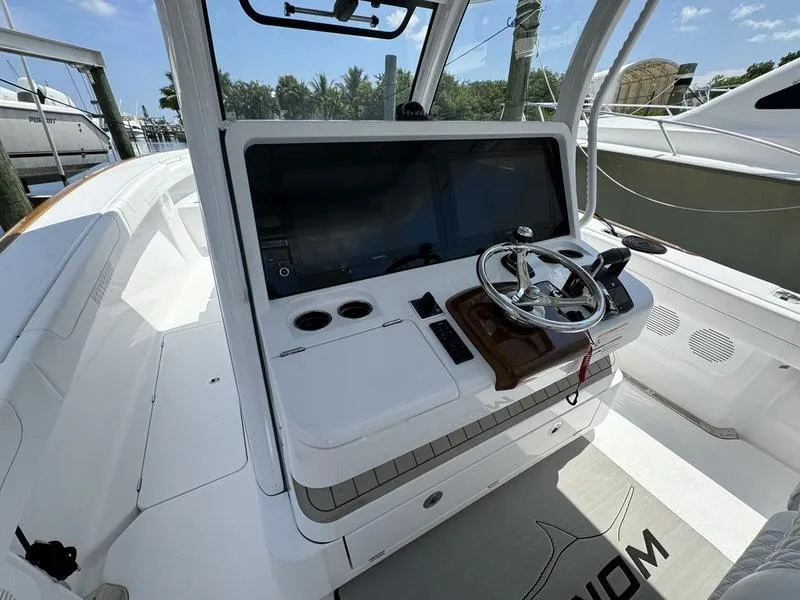 Slide: The Image of Phenom 37 boat cockpit, 2025 model, featuring modern steering and navigation controls. - 34
