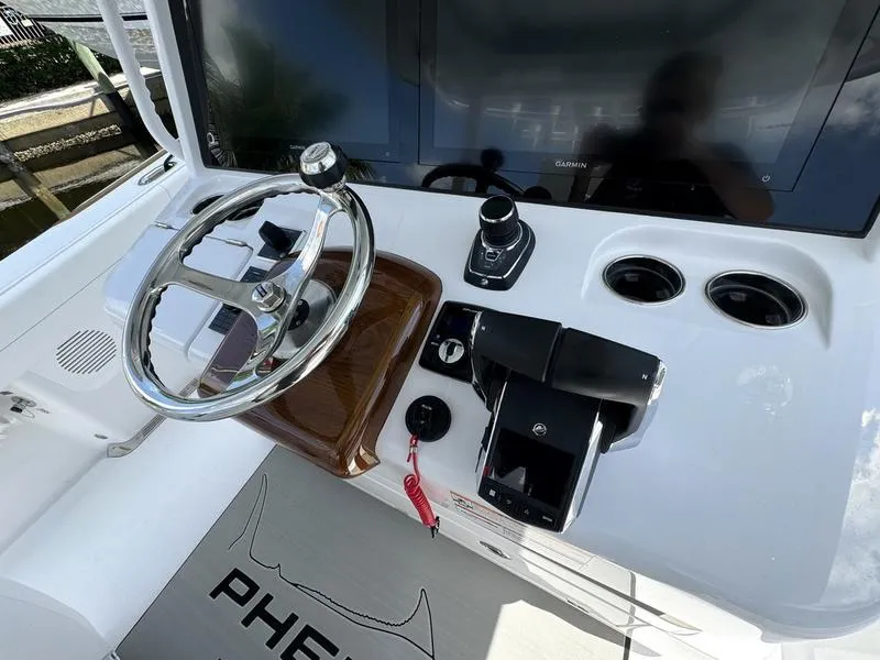 Slide: The Image of Phenom 37 boat dashboard, 2025 model, featuring steering wheel and control panel. - 37