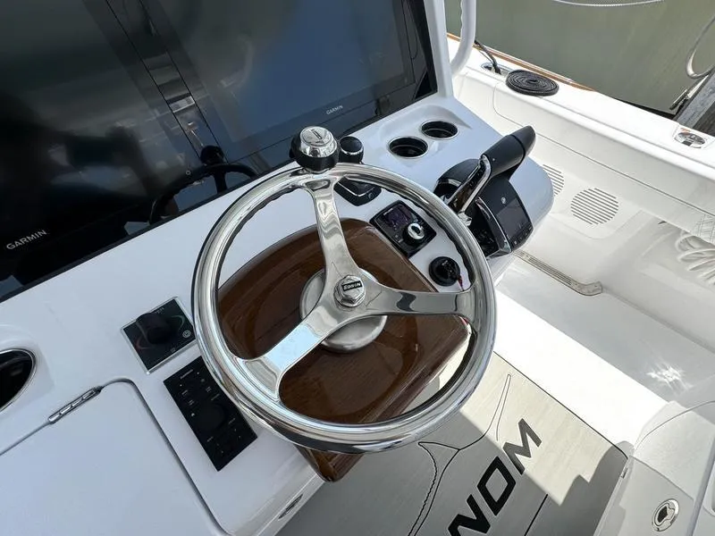 Slide: The Image of Phenom 37 boat helm with steering wheel and controls, 2025 model. - 38