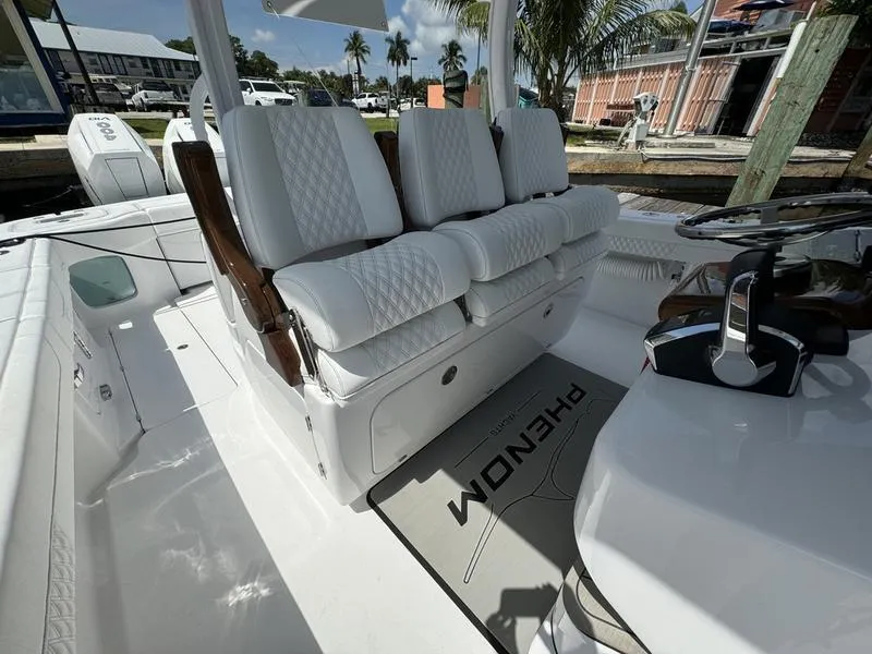 Slide: The Image of Phenom 37 boat interior, 2025 model, featuring luxurious white seating and modern controls. - 46