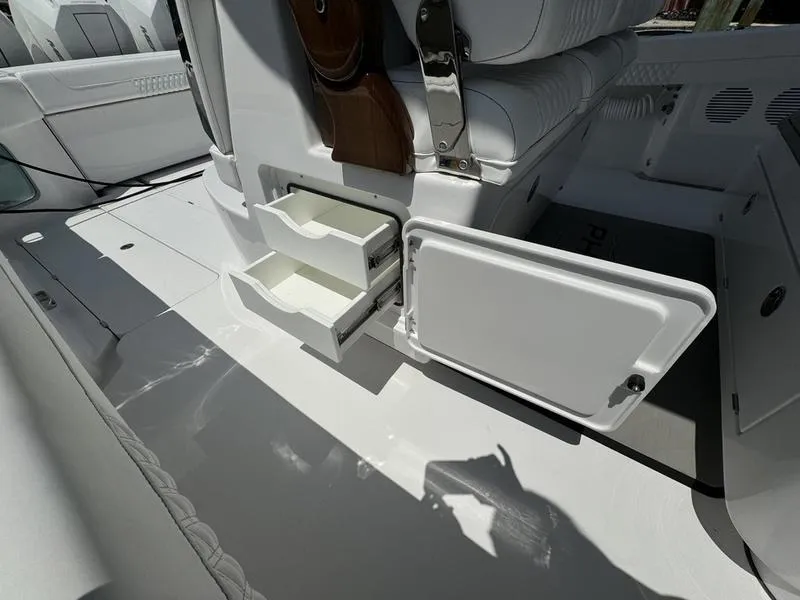 Slide: The Image of Phenom 37 boat interior, 2025 model, featuring storage compartments and white seating. - 47