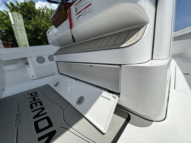 Slide: The Image of Phenom 37 boat interior storage compartment, 2025 model, open hatch, sleek white design. - 49