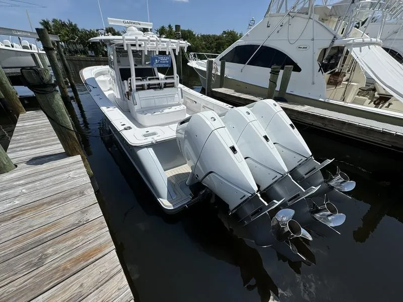 Slide: The Image of 2025 Phenom 37 boat docked with triple outboard engines. - 5