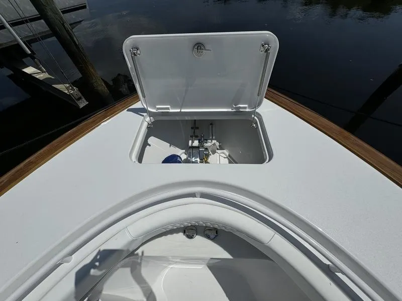 Slide: The Image of Phenom 37 boat deck with open hatch, 2025 model, showing storage compartment. - 6