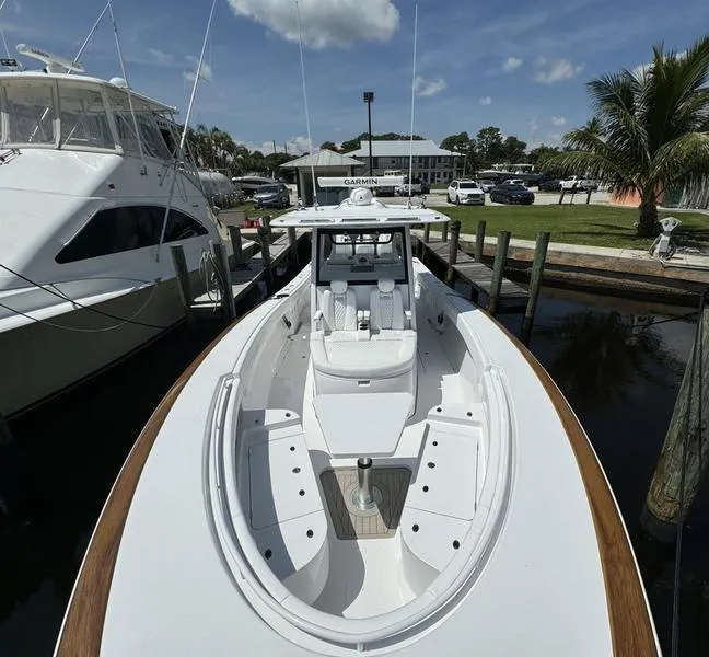 Slide: The Image of Phenom 37 boat docked, 2025 model, sleek design, sunny day, marina setting. - 8