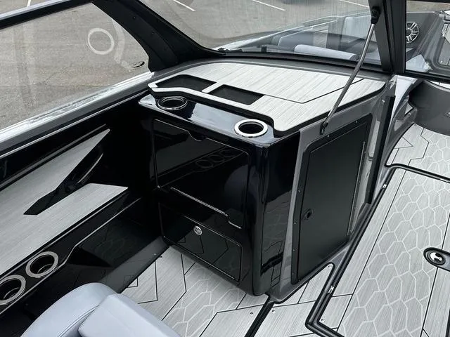 Slide: The Image of 2025 Yamaha Boats 222XD interior with sleek black cabinetry and modern design. - 6