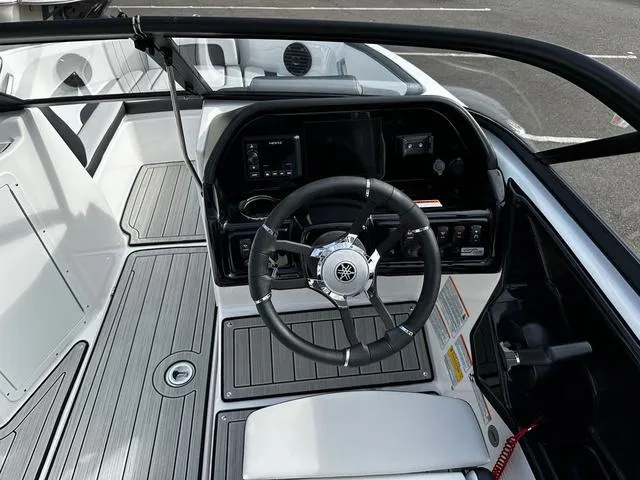 Slide: The Image of 2025 Yamaha Boats 195S cockpit with sleek steering wheel and modern dashboard controls. - 11