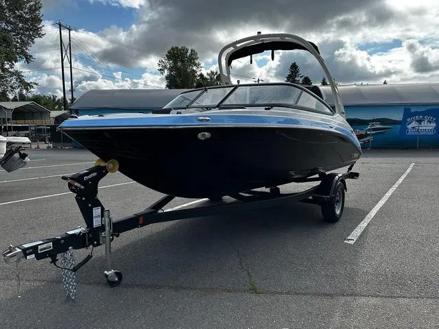 Slide: The Image of 2025 Yamaha Boats 195S on trailer in parking lot, cloudy sky background. - 4