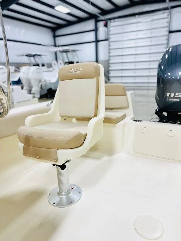 Slide: The Image of 2025 Scout 195 Sport Dorado boat interior with beige seating and Yamaha 115 engine. - 3