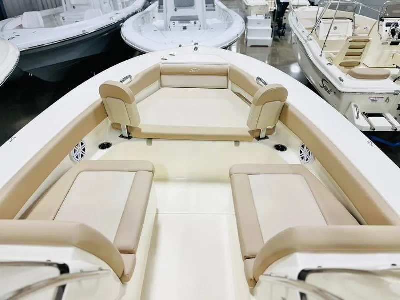 Slide: The Image of 2025 Scout 195 Sport Dorado boat interior with beige seating in showroom. - 5