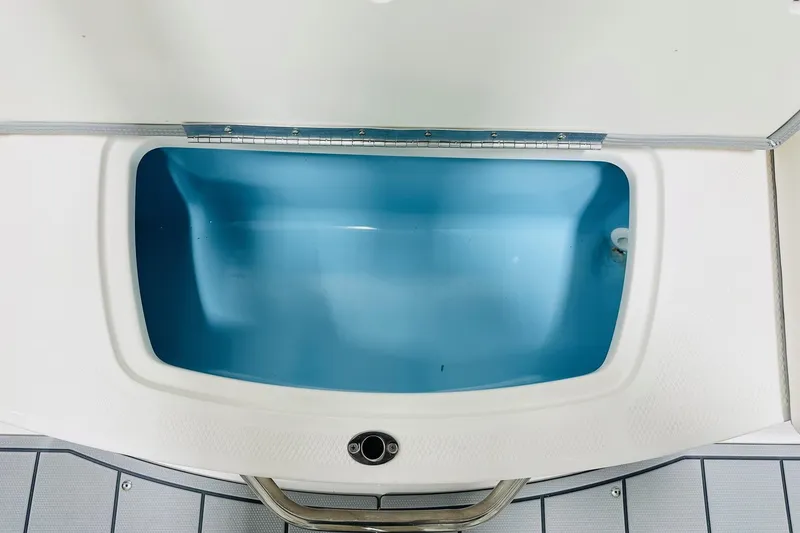 Slide: The Image of 2025 Chaparral 21 SSi OB boat storage compartment with blue interior. - 10