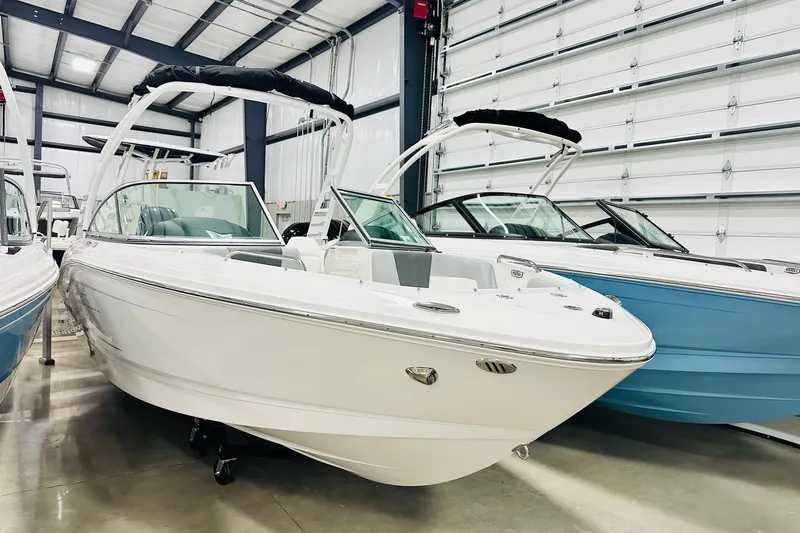 The Image of 2025 Chaparral 21 SSi OB boat in showroom, white hull, sleek design. - 2