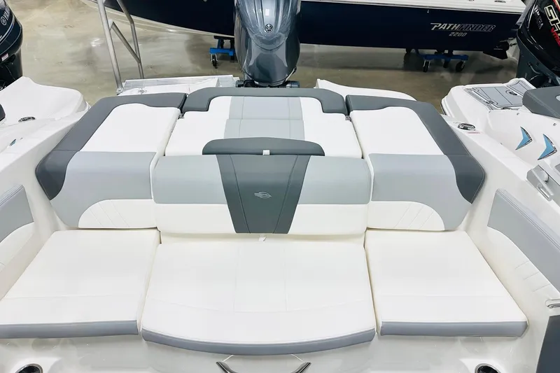 Slide: The Image of 2025 Chaparral 21 SSi OB boat interior with gray and white cushioned seating. - 9