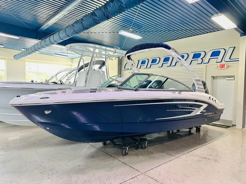 The Image of 2025 Chaparral 21 SSi OB boat in showroom, blue and white design. - 1