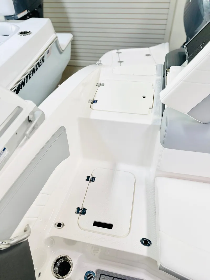 Slide: The Image of 2025 Chaparral 21 SSi OB boat interior with storage compartments and seating. - 10