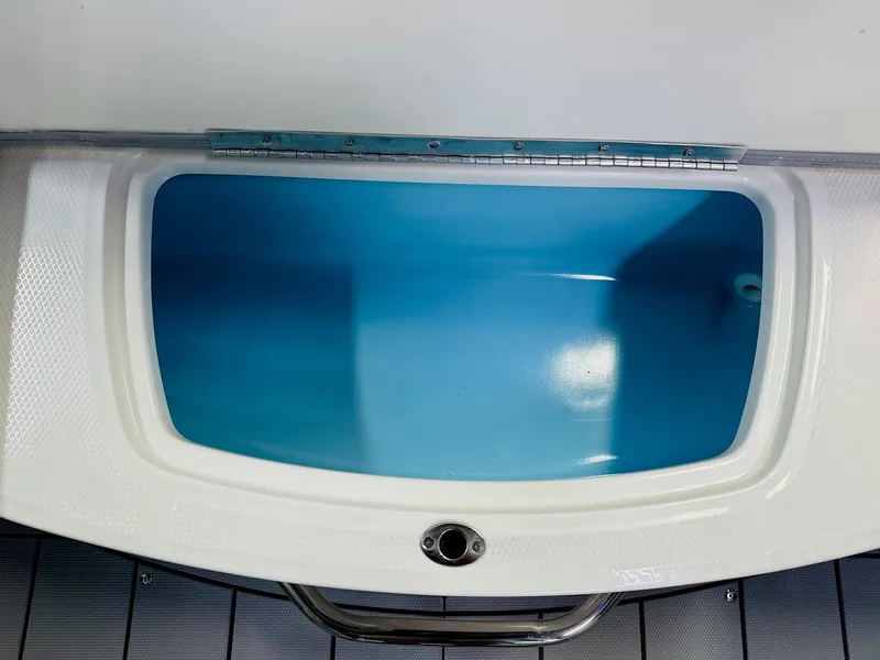Slide: The Image of 2025 Chaparral 21 SSi OB boat storage compartment with blue interior. - 9