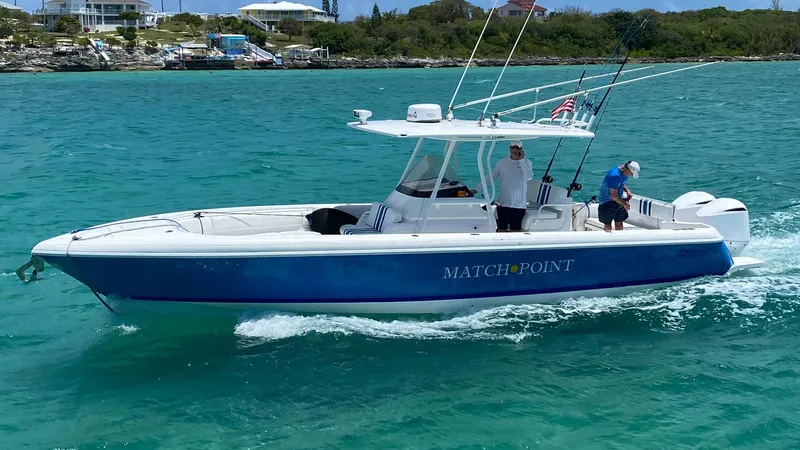Slide: The Image of 2011 Intrepid 32 boat cruising on turquoise water with two people onboard. - 0