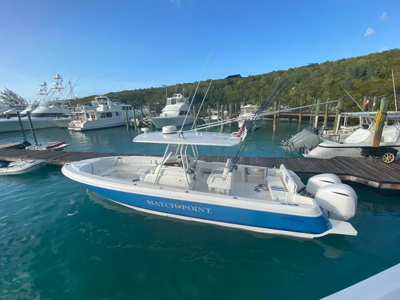 Slide: The Image of 2011 Intrepid 32 boat docked in marina, clear blue water, sunny day. - 1