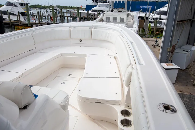 Slide: The Image of 2011 Intrepid 32 boat with spacious white seating area at a marina. - 10