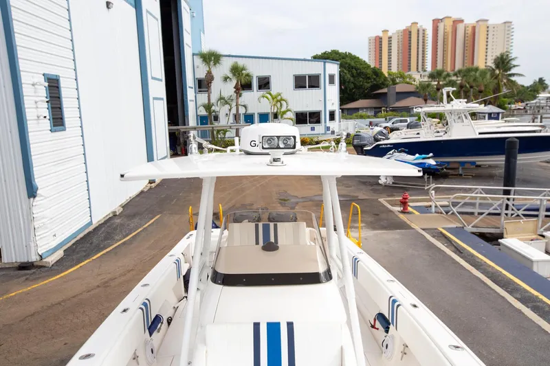 Slide: The Image of 2011 Intrepid 32 boat docked at marina with buildings in background. - 13