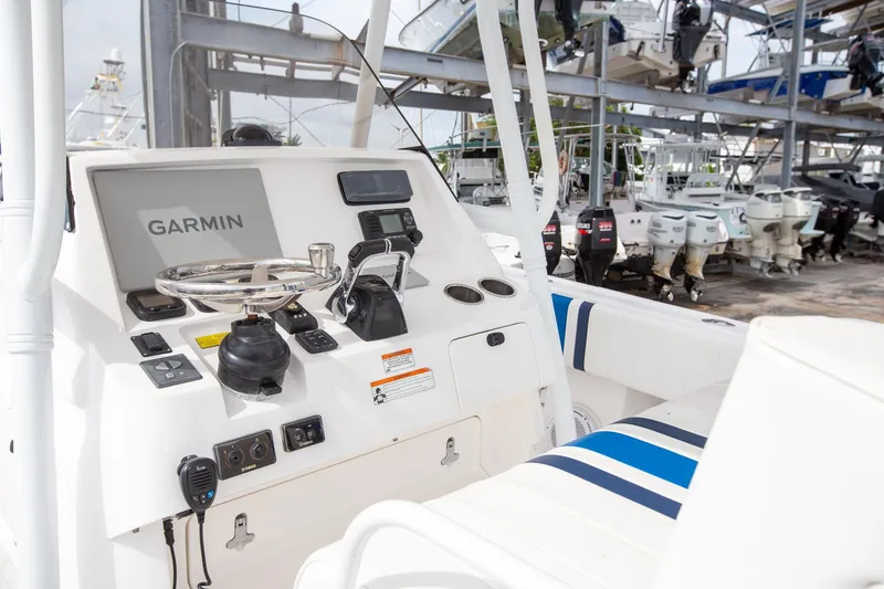 Slide: The Image of Intrepid 32 boat dashboard with Garmin navigation, 2011 model, in a marina setting. - 15