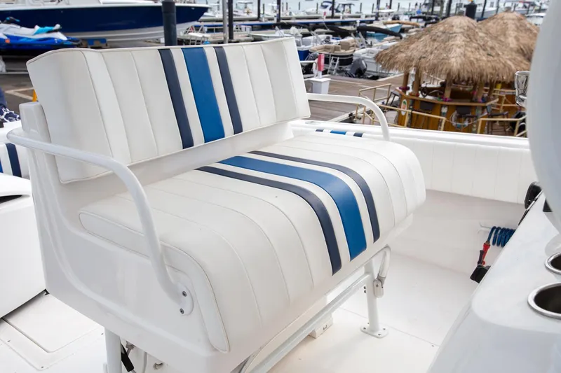 Slide: The Image of White and blue striped seating on 2011 Intrepid 32 boat at marina. - 18