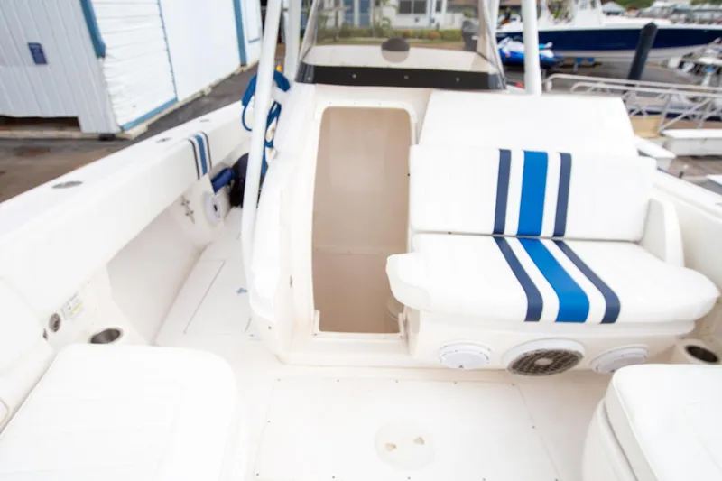 Slide: The Image of 2011 Intrepid 32 boat interior with white and blue striped seating. - 19