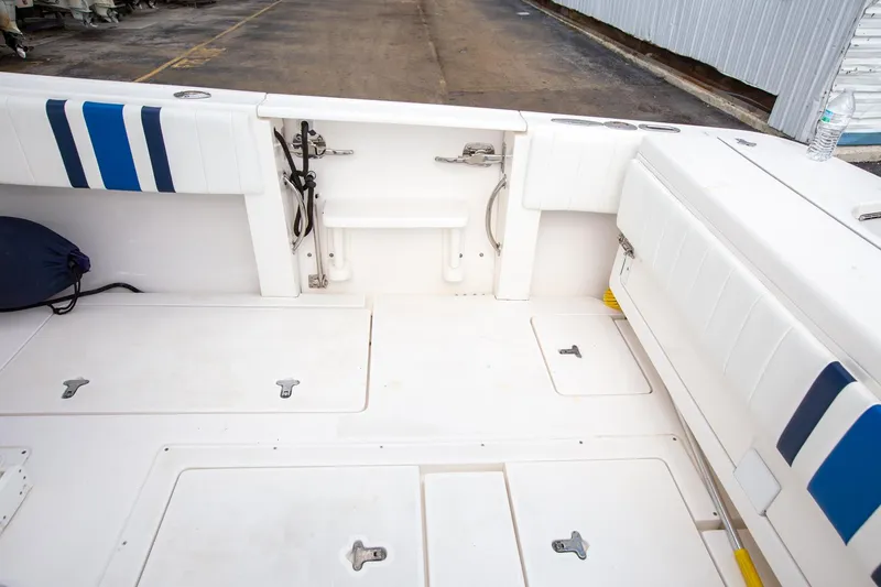 Slide: The Image of 2011 Intrepid 32 boat interior with white seating and storage compartments. - 21