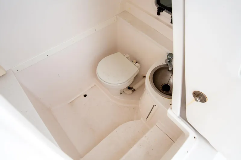 Slide: The Image of 2011 Intrepid 32 boat bathroom with toilet and sink. - 22