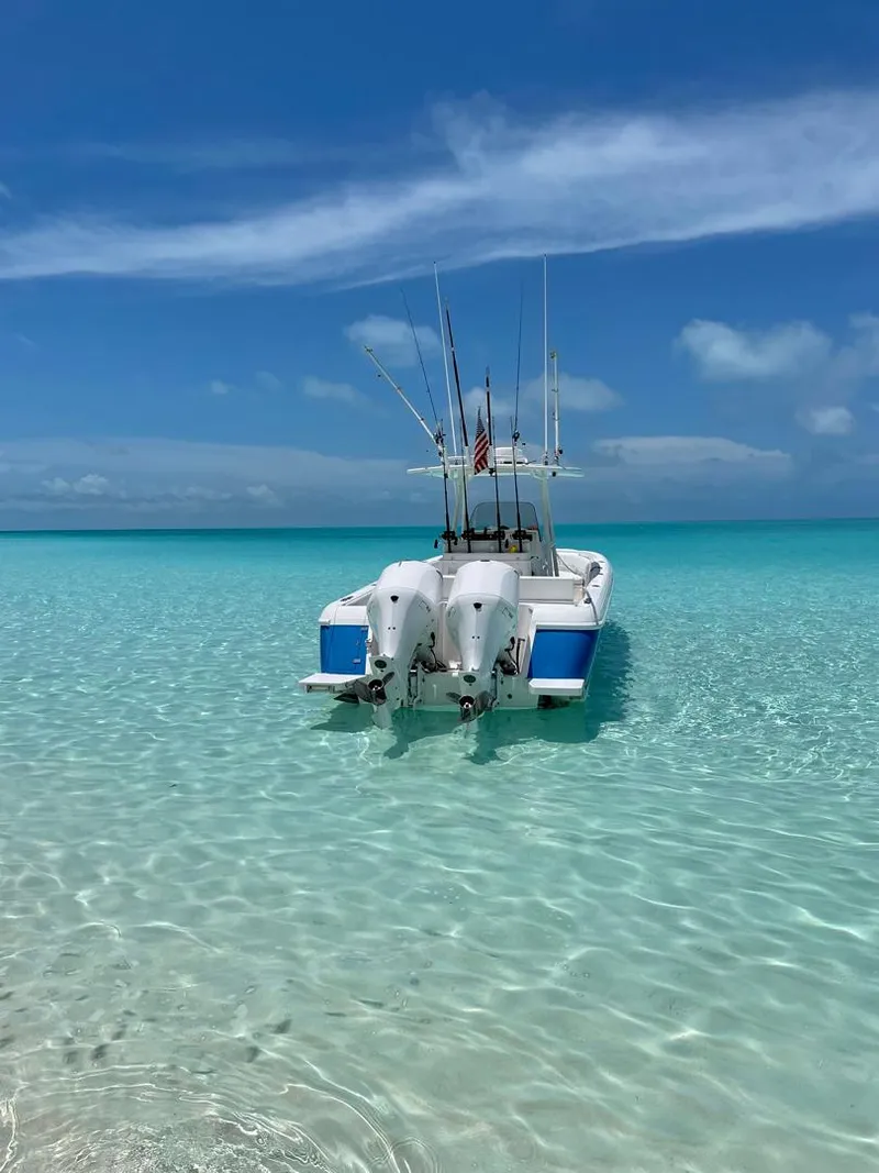 Slide: The Image of Intrepid 32 boat, 2011 model, anchored in clear turquoise water under a blue sky. - 3