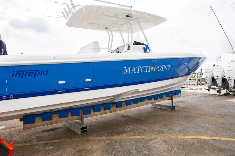 Slide: The Image of 2011 Intrepid 32 boat "Match Point" on display at a marina. - 7