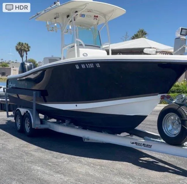 The Image of 2018 Mako 234 Center Console boat on trailer, parked outdoors. - 1
