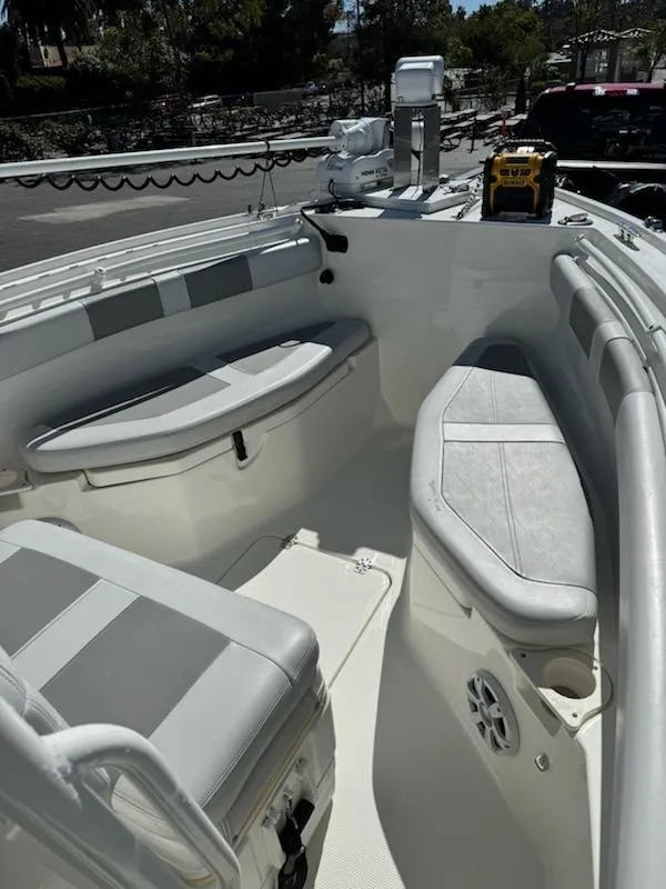 Slide: The Image of 2018 Mako 234 Center Console boat interior with seating and storage. - 10