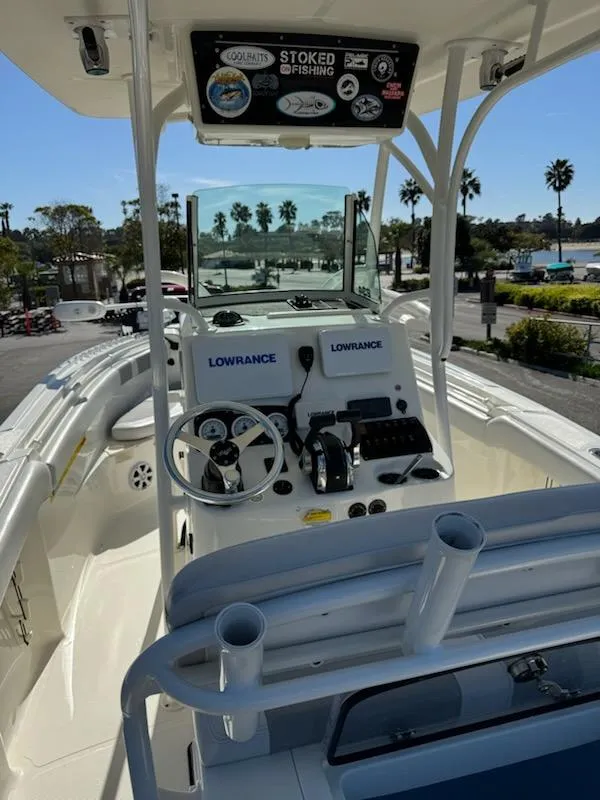Slide: The Image of 2018 Mako 234 Center Console boat with Lowrance electronics, docked in a sunny marina. - 11