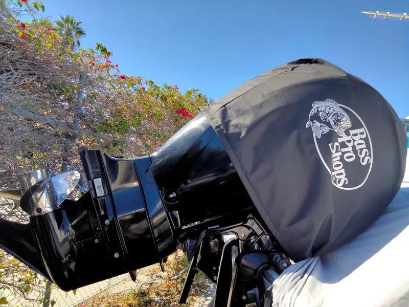 Slide: The Image of Bass Pro Shops engine cover on Mako 234 Center Console, 2018 model, outdoors. - 8