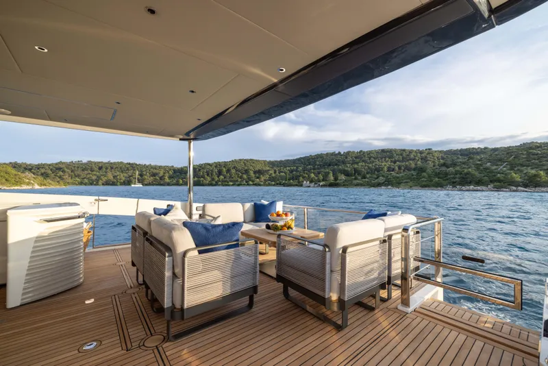 Slide: The Image of Luxurious 2024 Absolute NAVETTA 75 yacht deck with elegant seating and scenic ocean view. - 16