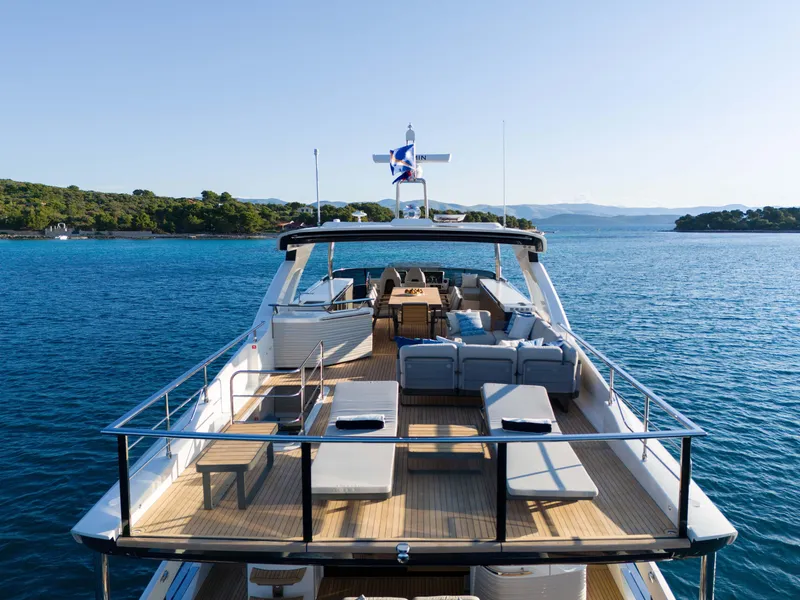 Slide: The Image of Luxurious 2024 Absolute NAVETTA 75 yacht on serene blue waters. - 6