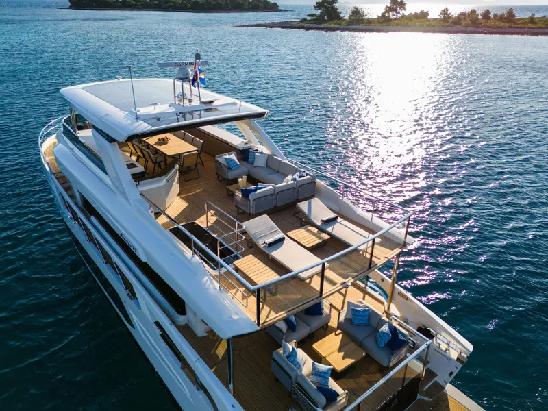 Slide: The Image of Luxurious 2024 Absolute NAVETTA 75 yacht cruising on serene waters. - 7