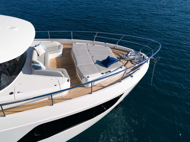 Slide: The Image of Luxurious 2024 Absolute NAVETTA 75 yacht with spacious deck and seating area. - 8