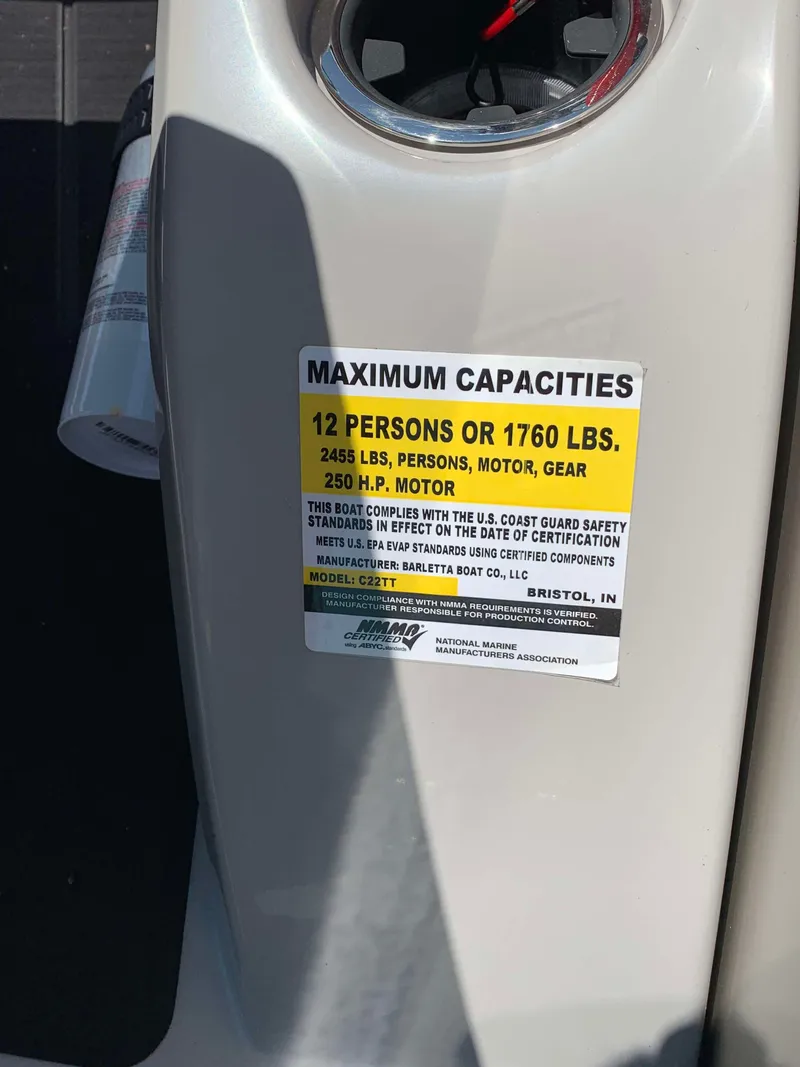 Slide: The Image of Capacity label on 2025 Barletta Cabrio 22UC boat, showing weight and passenger limits. - 11