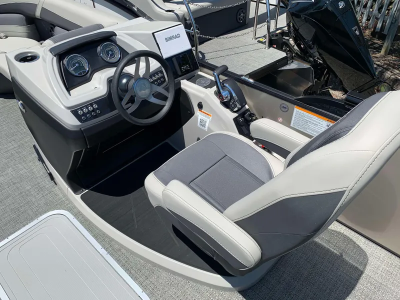 Slide: The Image of 2025 Barletta Cabrio 22UC boat interior with steering wheel and captain's chair. - 9